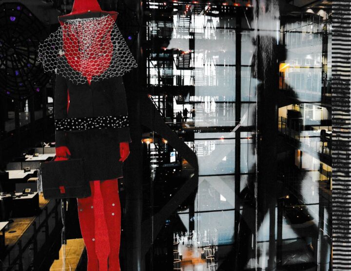 A 3D collage made with magazine clippings shows a woman wearing a red hood and a white veil covering her face, a black suit, red gloves, red pants, and holding a black briefcase with a red latch. She is walking past a row of empty office cubicles with computers and landline phones. A shadow of a man walking toward the woman from the side is reflected in front of a wall of windows. Behind the wall of windows is an atrium stairwell that shows floors above and below them and other people in the distance.